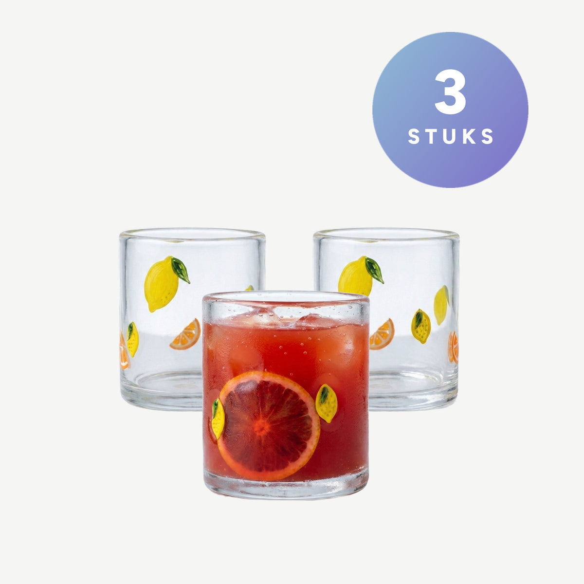 Set van 3 J-Line waterglazen met citrusfruitprint, een glas gevuld met ijs en sinaasappel
